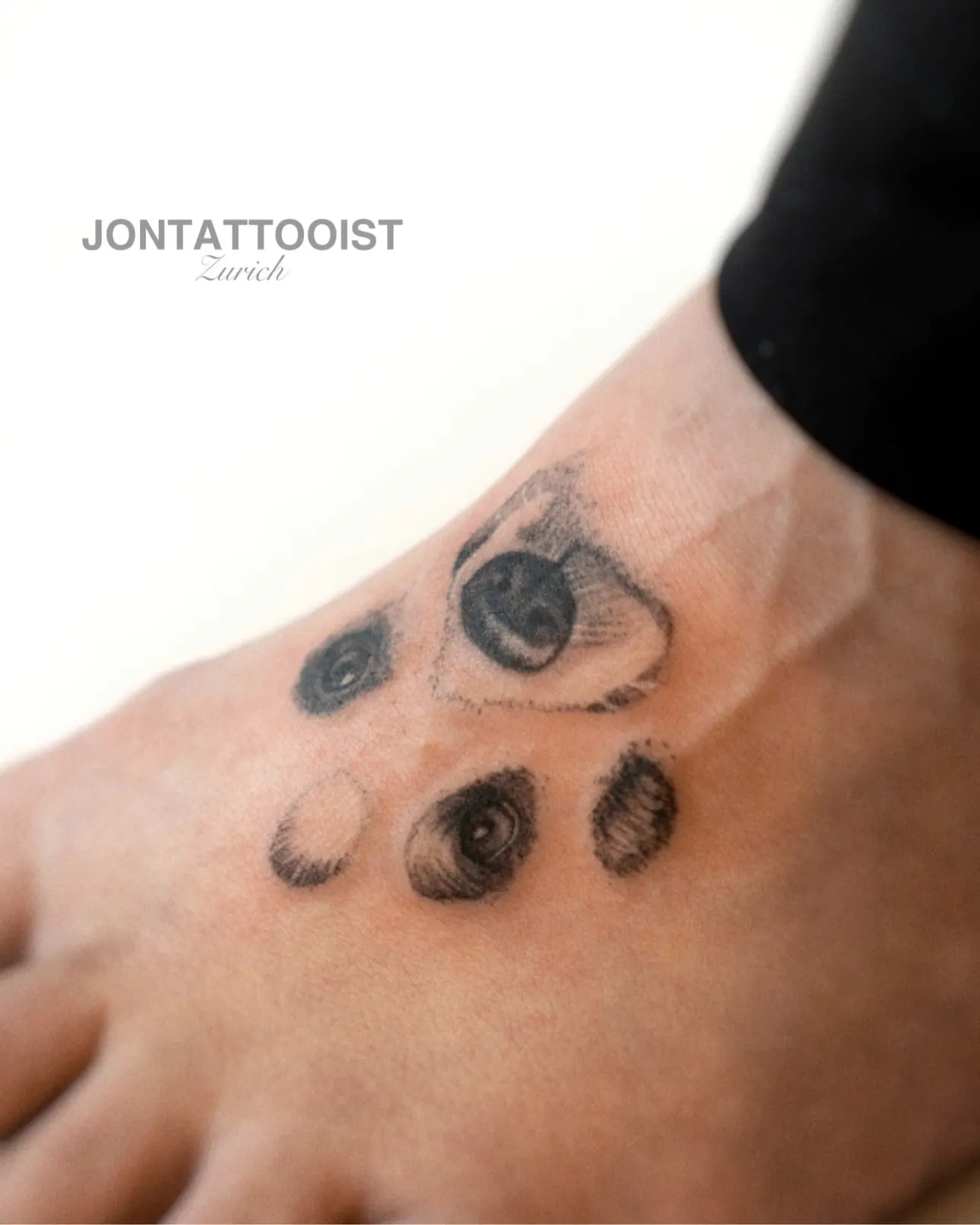 Paw print tattoo with integrated dog face on foot